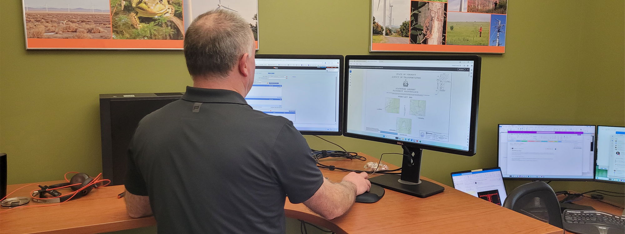 A Stantec employee works at a computer.