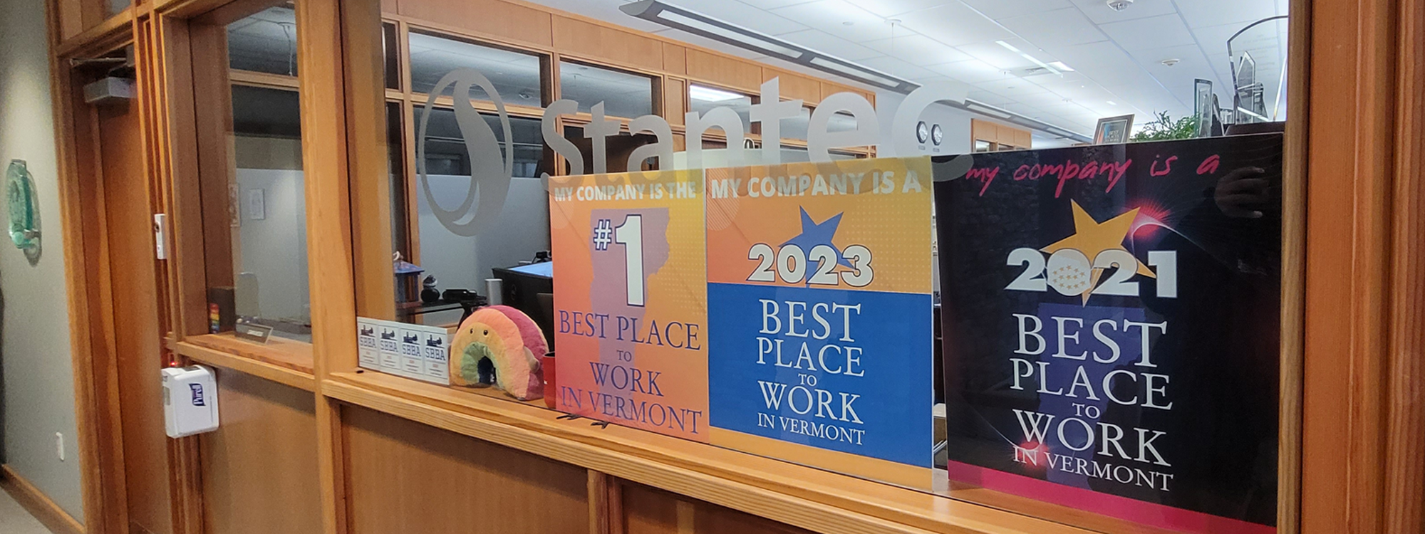 Stantec's "Best Place To Work" awards displayed in the office window.